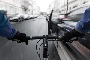 moving bicycle about approaching open car door