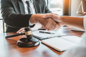 man in business suit shaking hands with client