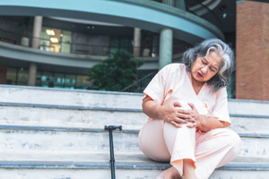 elderly woman sitting on the stairs